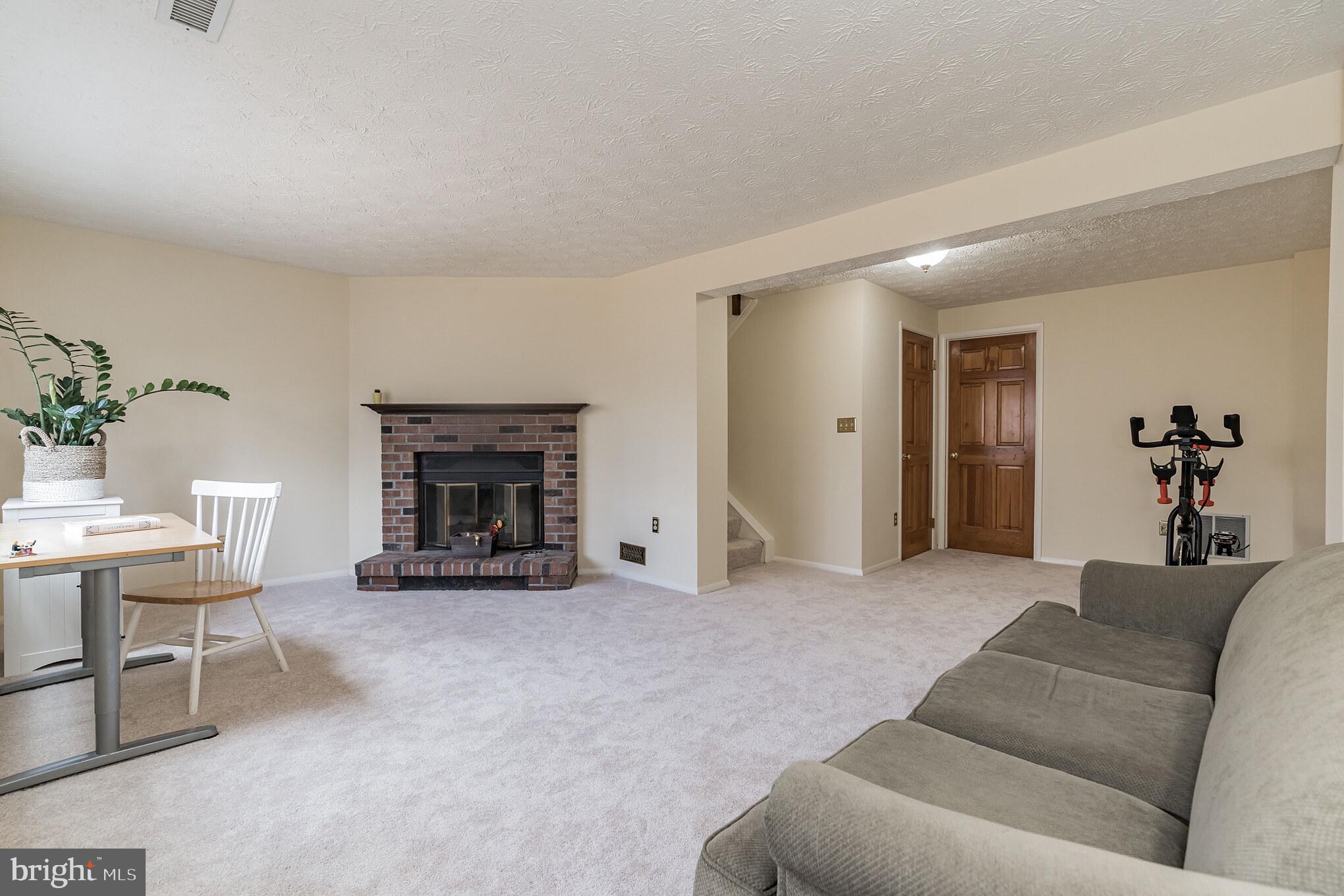 1610 Barnstead Drive Reston, VA 20194 - Photo 23 of 33 a living room with furniture and a fireplace