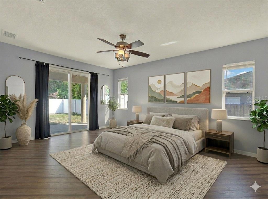 4400 Dior Road Spring Hill, FL 34609 - Photo 21 of 37 a bedroom with a large bed and a large window