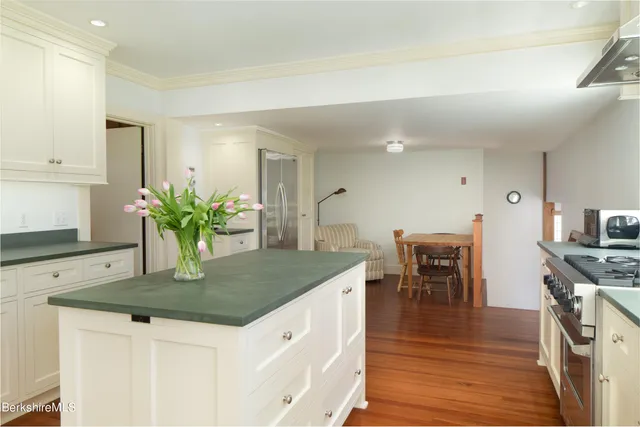 a living room with a floor to ceiling window and a lawn chair
