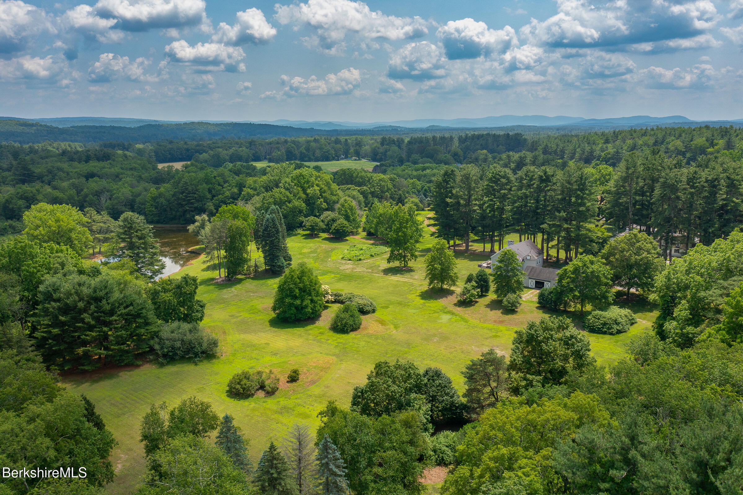 25 Sheffield Road Egremont, MA 01230 - Photo 69 of 71 a view of a garden with lawn chairs and large trees