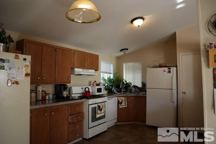 2183 Barberry Way Reno, NV 89512 - Photo 6 of 17 a kitchen with a refrigerator and cabinets