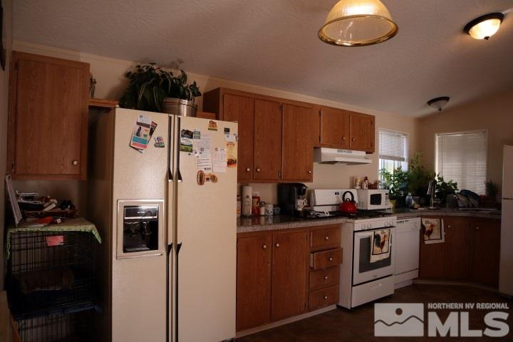 2183 Barberry Way Reno, NV 89512 - Photo 7 of 17 a white refrigerator freezer sitting inside of a kitchen