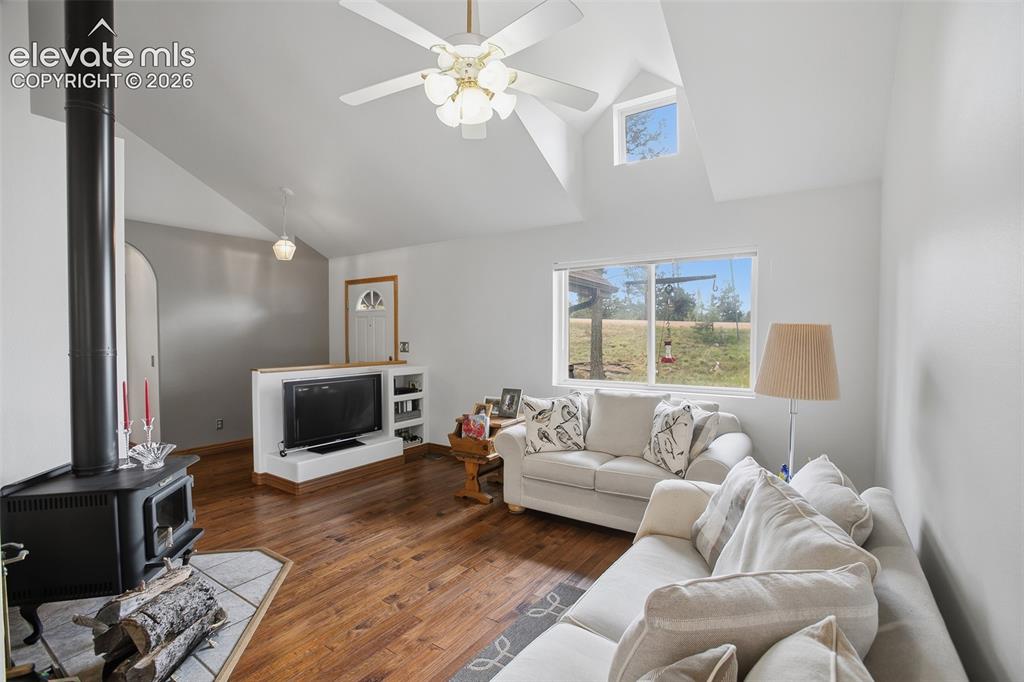 877 North Mountain Estates Road Florissant, CO 80816 - Photo 2 of 23 a living room with furniture a flat screen tv and a window