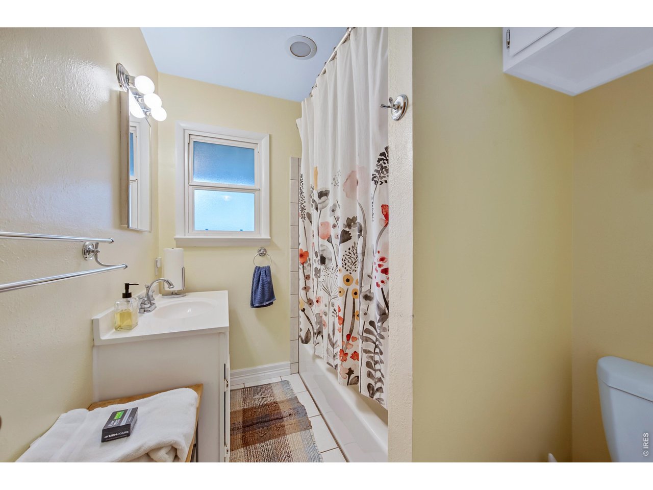 1709 Dale Court Fort Collins, CO 80521 - Photo 14 of 26 a bathroom with a sink a mirror and a shower