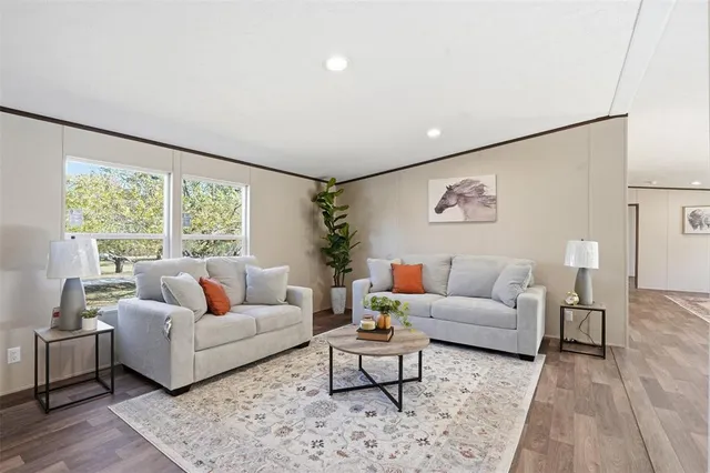 a living room with furniture and a large window