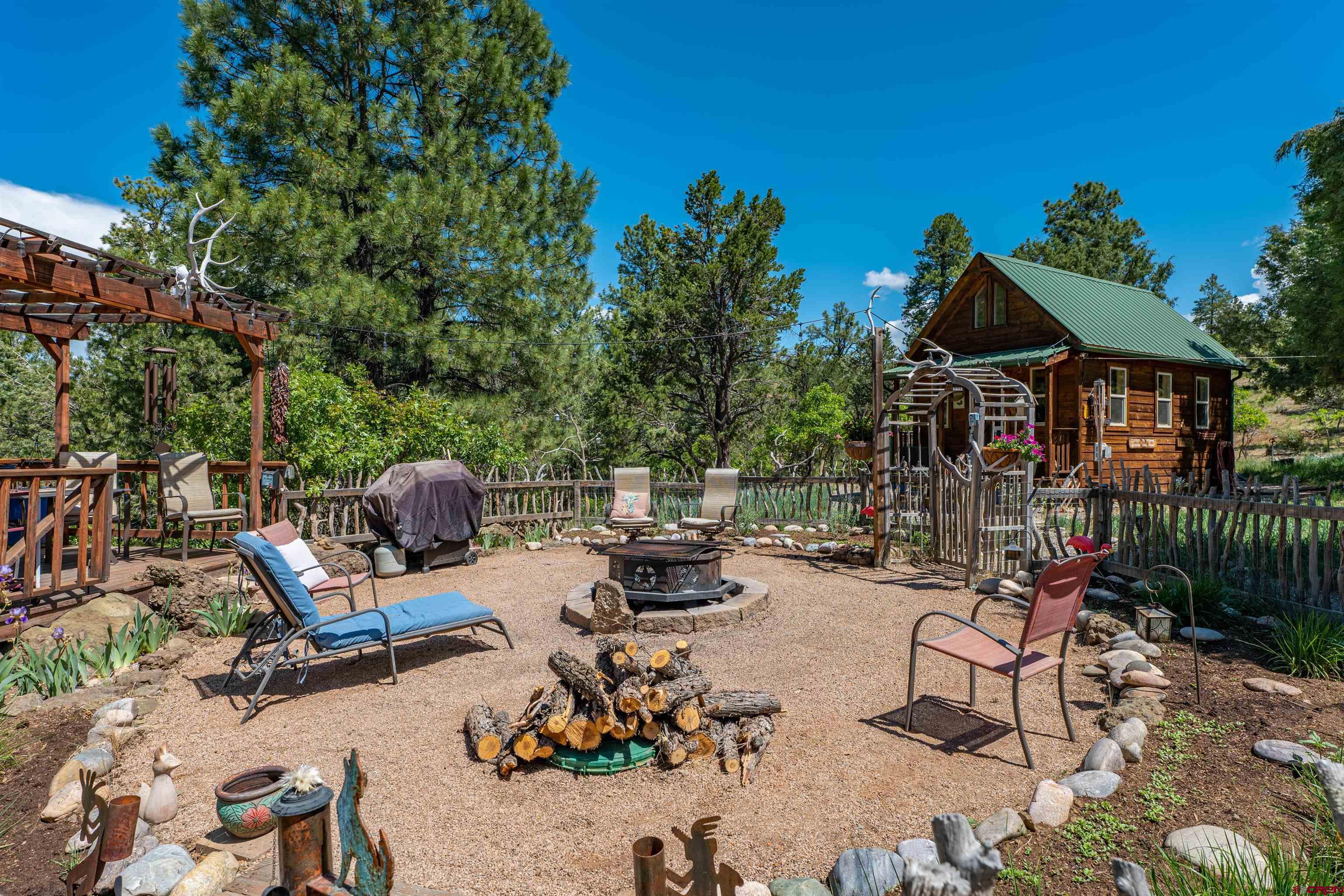 10 Alpine Drive Durango, CO 81301 - Photo 12 of 24 a view of a patio with couple of chairs and a fire pit