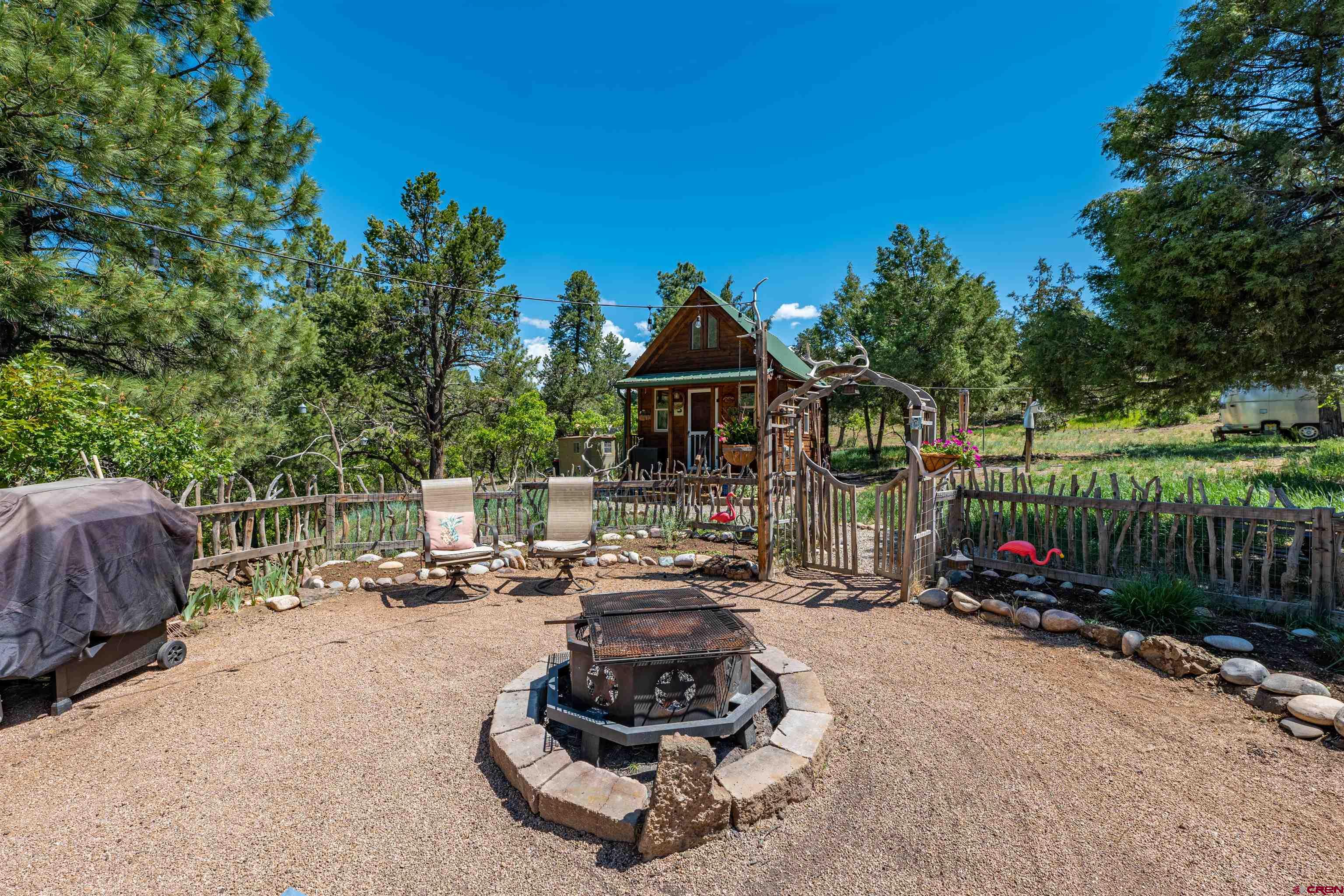 10 Alpine Drive Durango, CO 81301 - Photo 13 of 24 a view of a patio with couches and a table and chairs with wooden fence