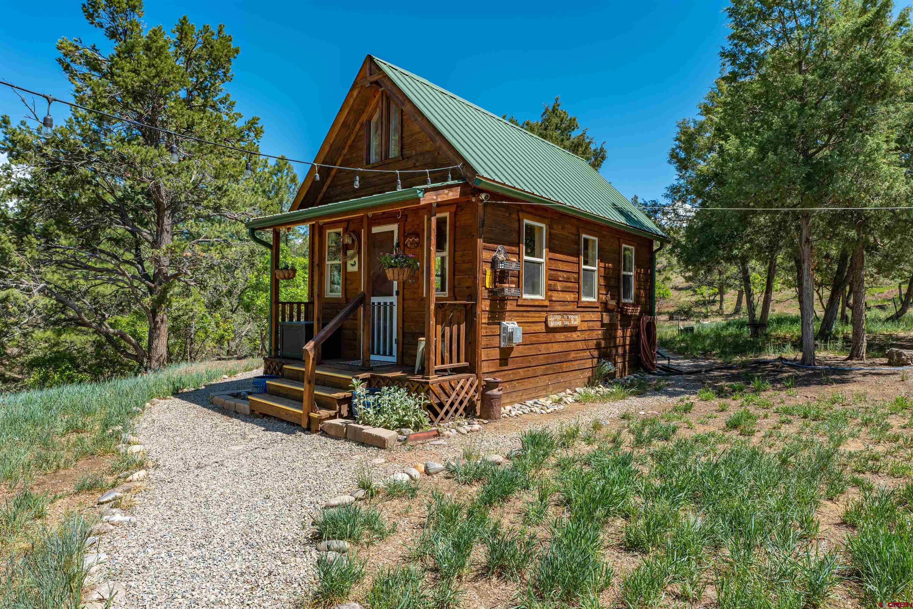 10 Alpine Drive Durango, CO 81301 - Photo 2 of 24 a view of a wooden house with a yard