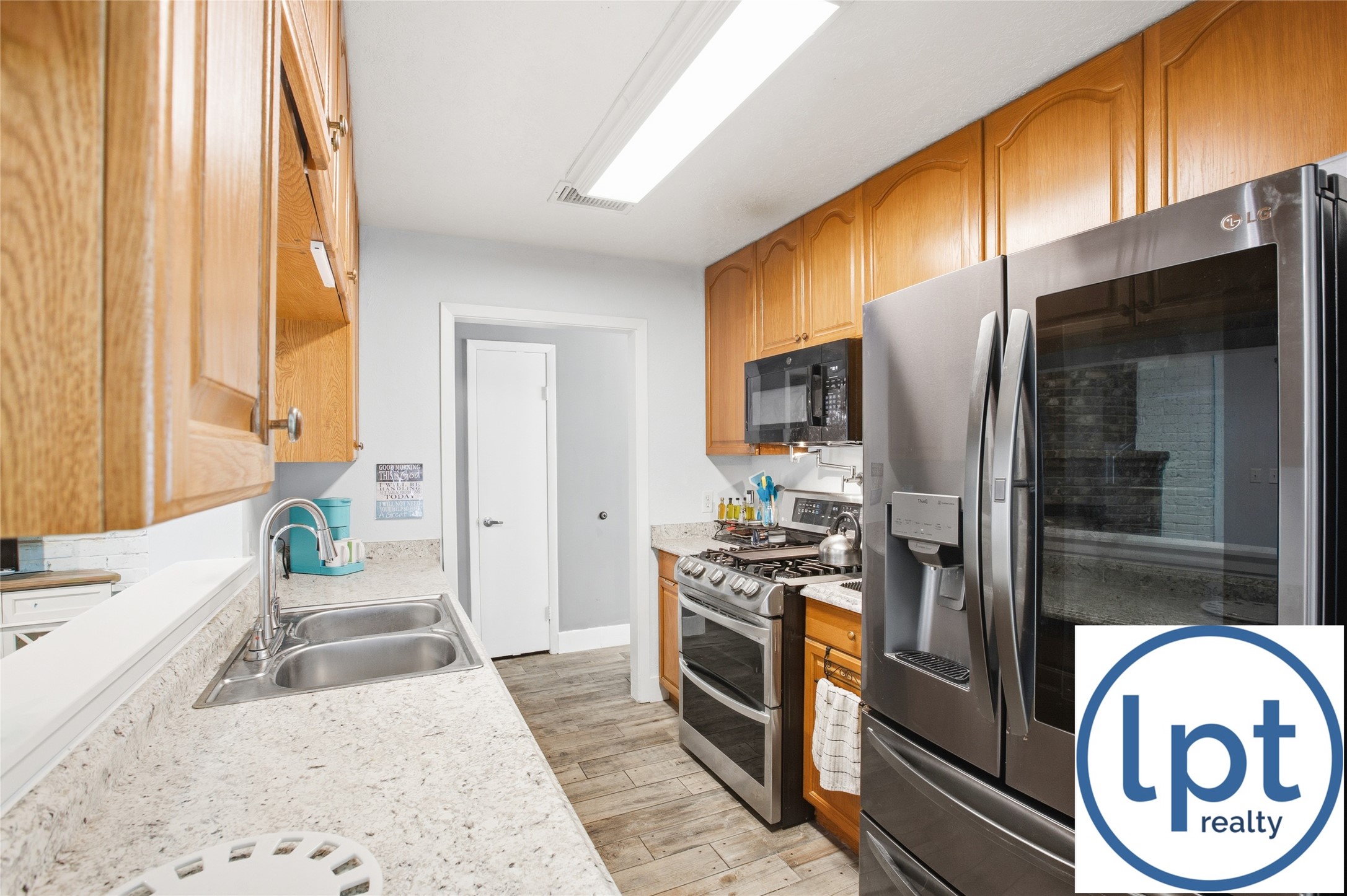 29011 Binefield Street Spring, TX 77386 - Photo 12 of 40 a kitchen with stainless steel appliances granite countertop a stove a refrigerator and a microwave