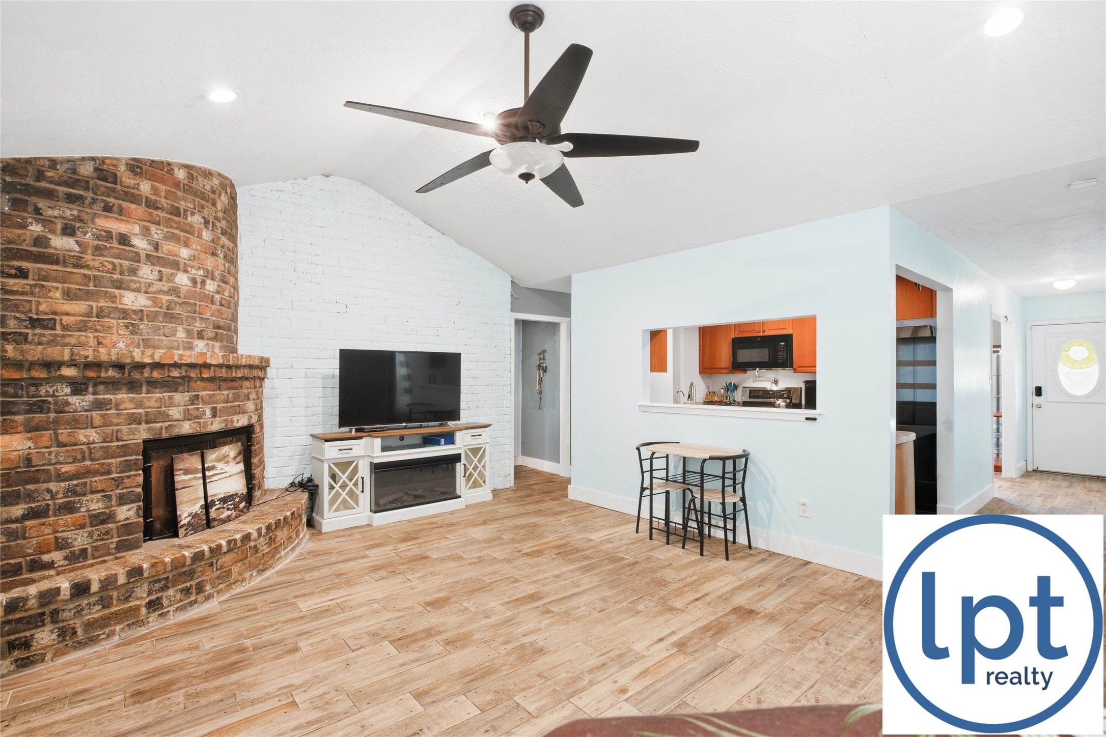 29011 Binefield Street Spring, TX 77386 - Photo 17 of 40 a living room with furniture a fireplace and a flat screen tv
