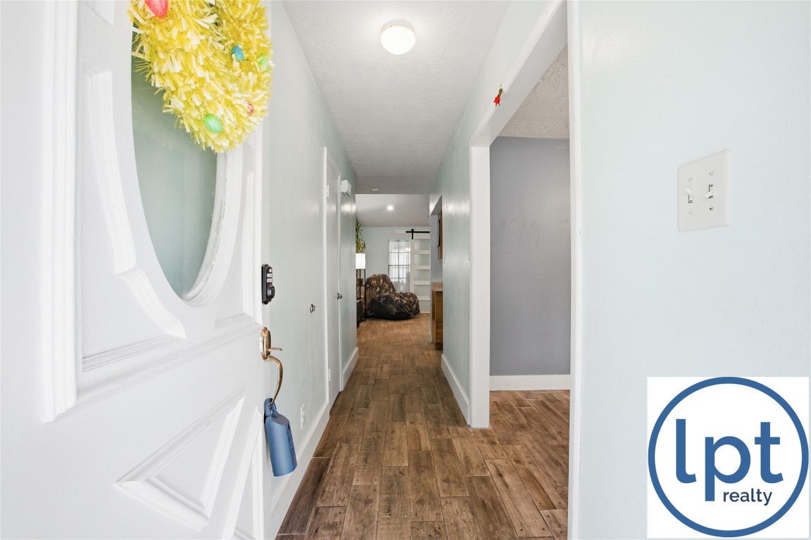 29011 Binefield Street Spring, TX 77386 - Photo 6 of 40 a view of a hallway with wooden floor and a dining room