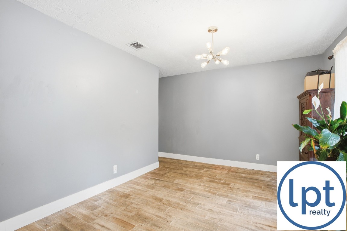 29011 Binefield Street Spring, TX 77386 - Photo 7 of 40 wooden floor in an empty room with a window