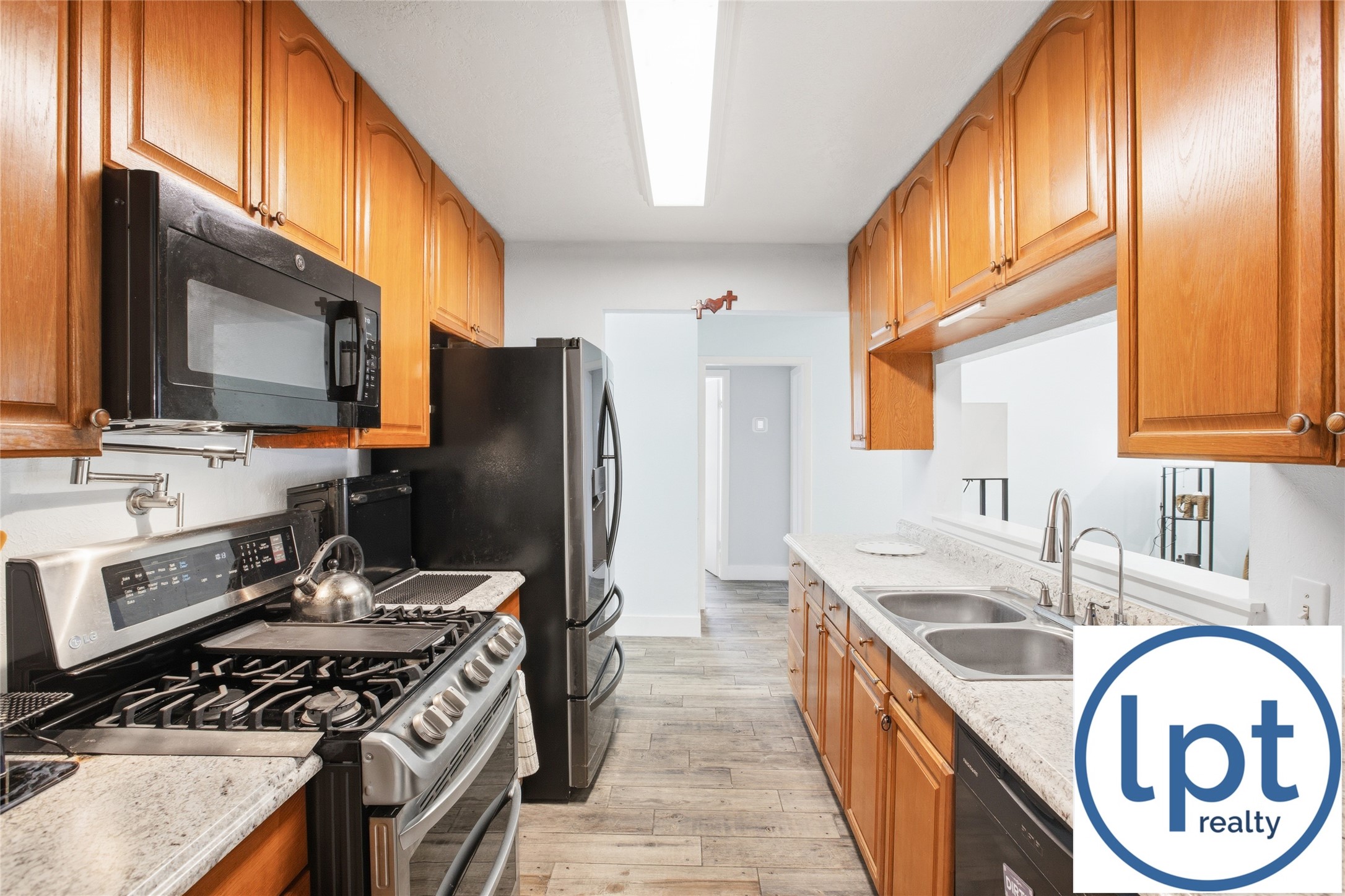 29011 Binefield Street Spring, TX 77386 - Photo 9 of 40 a kitchen with stainless steel appliances granite countertop a sink stove and refrigerator