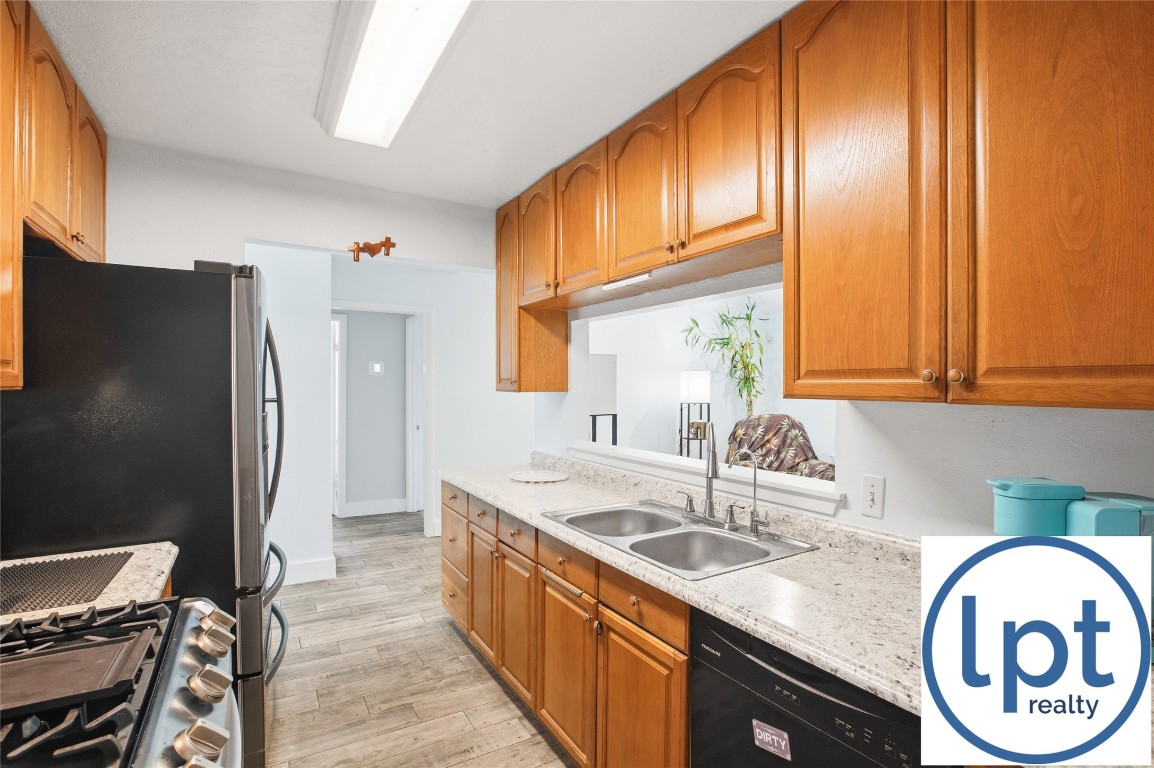 29011 Binefield Street Spring, TX 77386 - Photo 10 of 40 a kitchen with stainless steel appliances granite countertop a sink a refrigerator and a stove