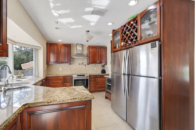 a bathroom with a granite countertop sink a toilet and a mirror
