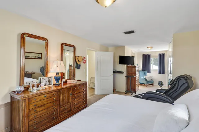 a view of a house with swimming pool and sitting area