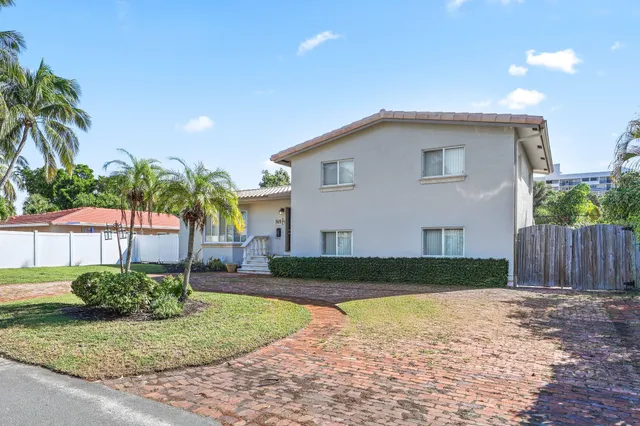 a living room with furniture a rug and white walls