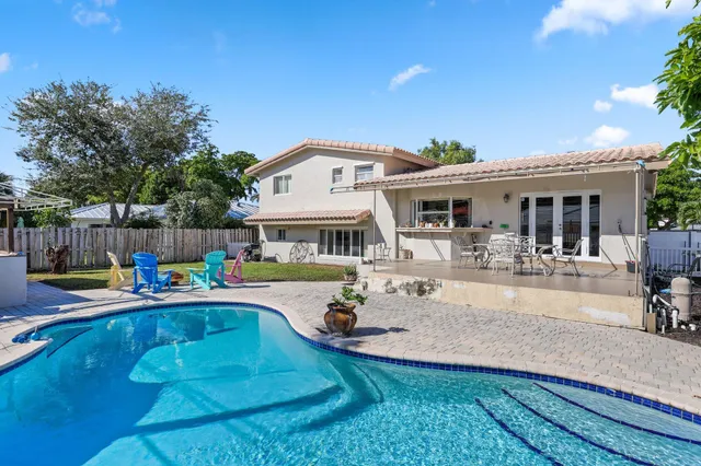 an aerial view of a house with a yard and potted plants