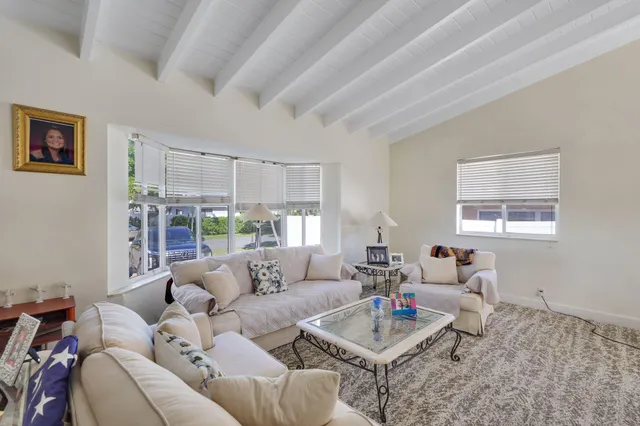 a large kitchen with kitchen island granite countertop a large island in the center and stainless steel appliances