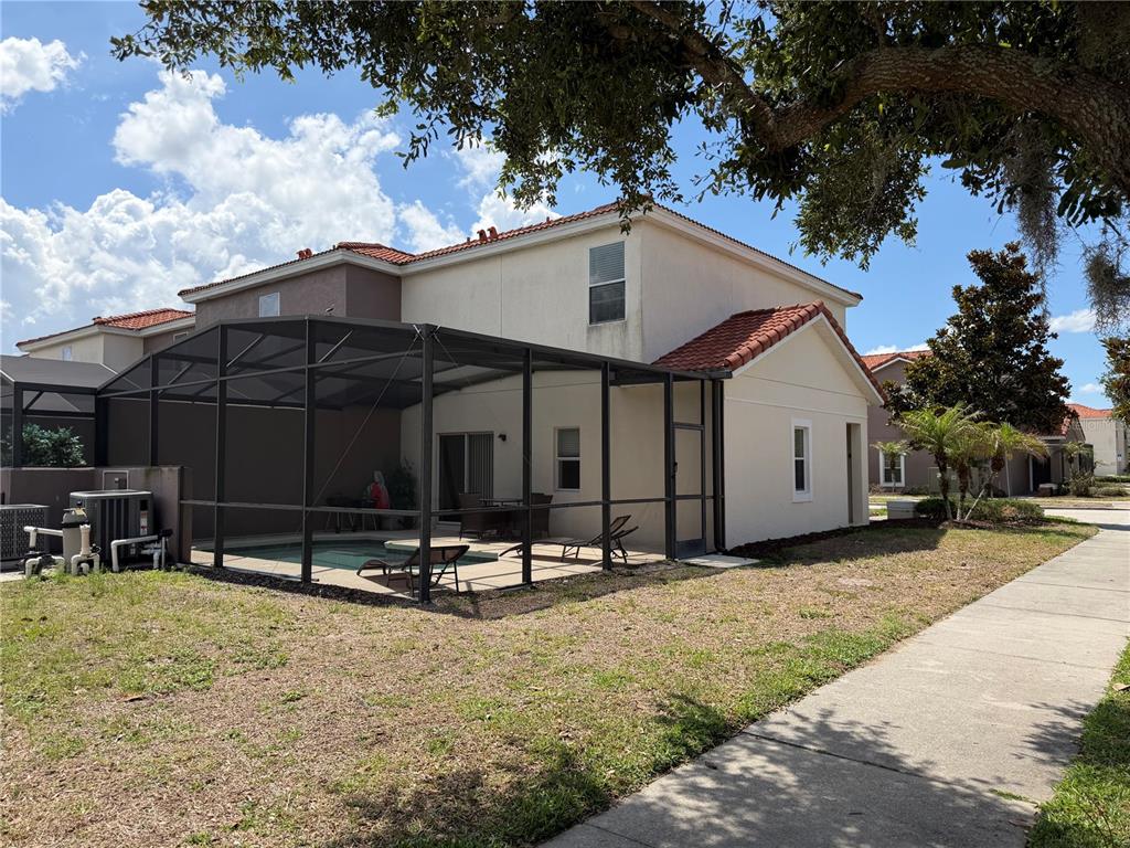 4573 Ada Lane Kissimmee, FL 34746 - Photo 25 of 37 a backyard of a house with barbeque oven fire pit table and chairs
