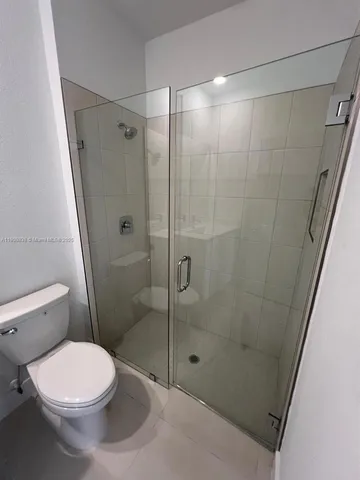 an empty room with windows and entrance