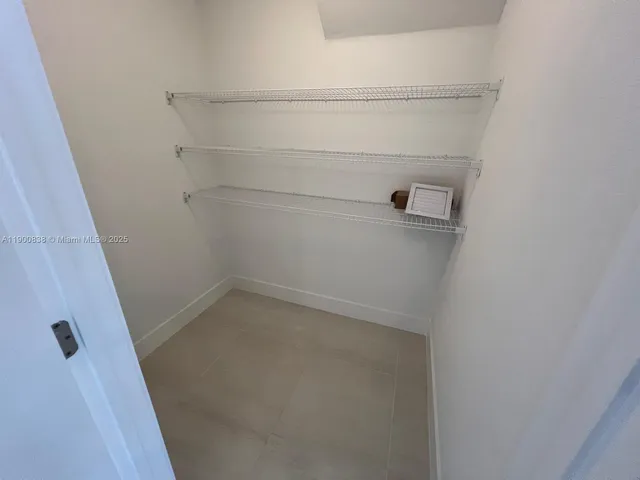 a view of a hallway with wooden floor and entryway