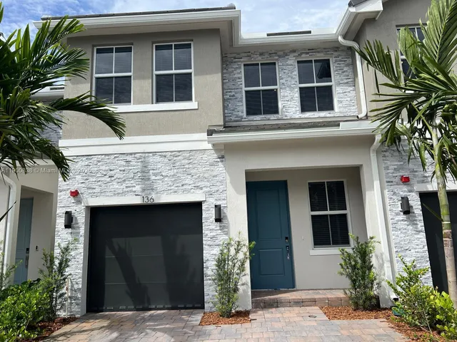 a front view of a house with a garage