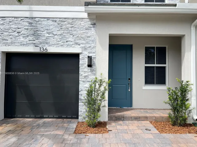 a view of a kitchen with a sink and a refrigerator