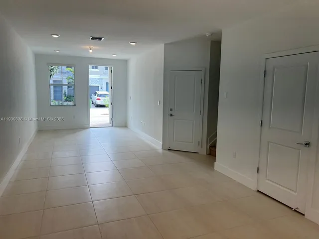 a view of a kitchen with a sink and a window