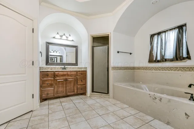 a bathroom with a tub sink and mirror