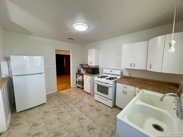 a kitchen with a sink a stove and refrigerator