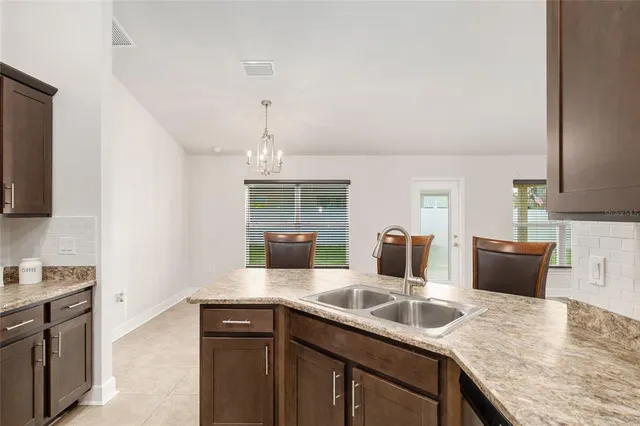 a bathroom with a granite countertop sink mirror and vanity
