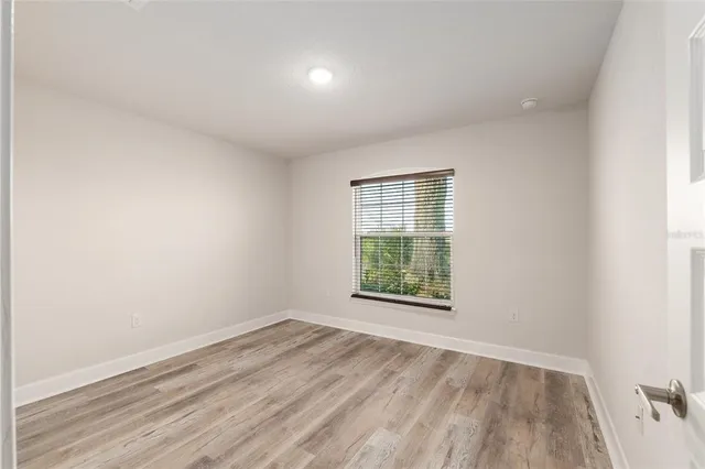 a view of a house with a big yard and potted plants