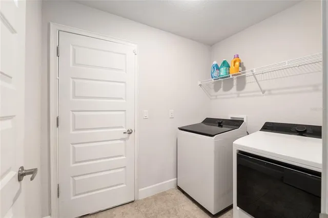 an aerial view of residential houses with outdoor space and city view