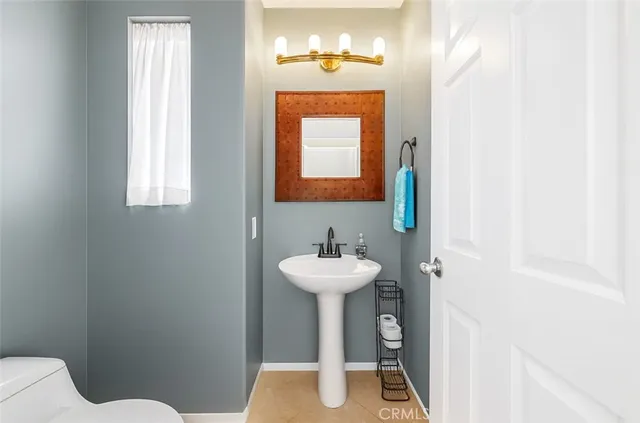 a bathroom with a sink a mirror and a toilet