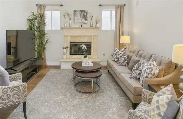 a living room with furniture a fireplace and a flat screen tv