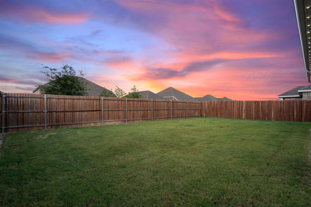 2232 Sun Star Drive Haslet, TX 76052 - Photo 12 of 40 a view of a backyard with wooden fence