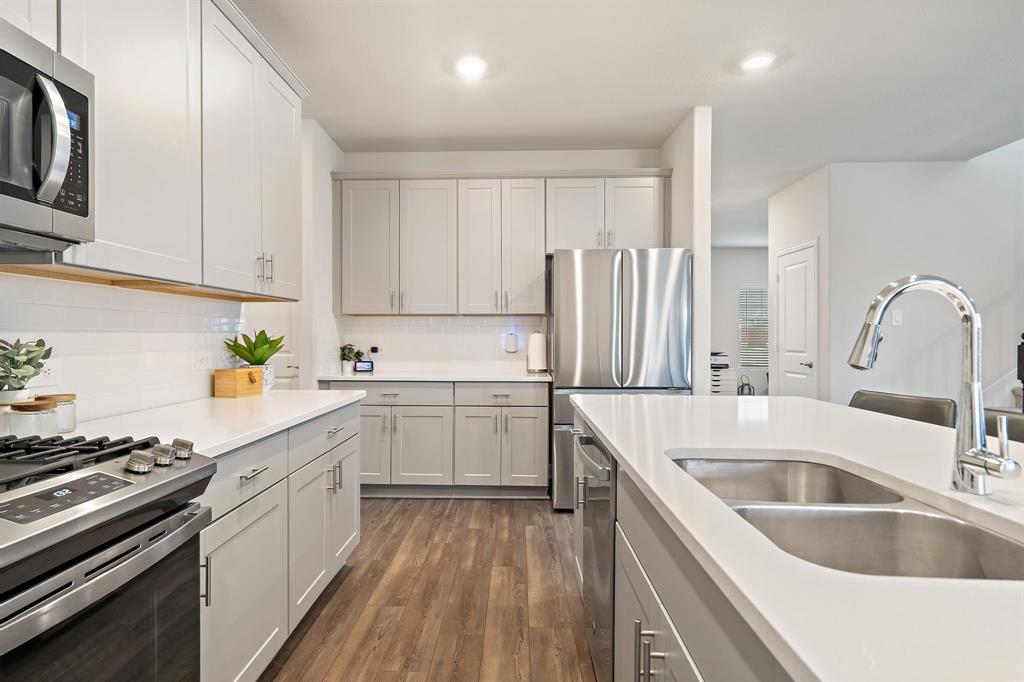 2232 Sun Star Drive Haslet, TX 76052 - Photo 18 of 40 a kitchen with a sink stove and refrigerator