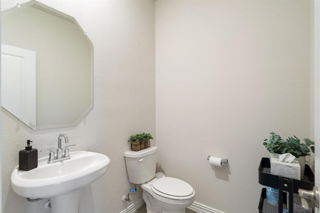 2232 Sun Star Drive Haslet, TX 76052 - Photo 21 of 40 a bathroom with a toilet a sink and a mirror