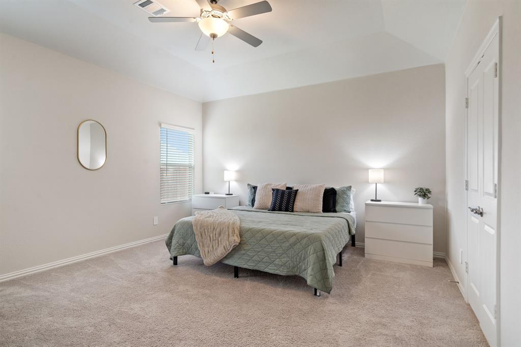 2232 Sun Star Drive Haslet, TX 76052 - Photo 23 of 40 a spacious bedroom with a bed and a chandelier