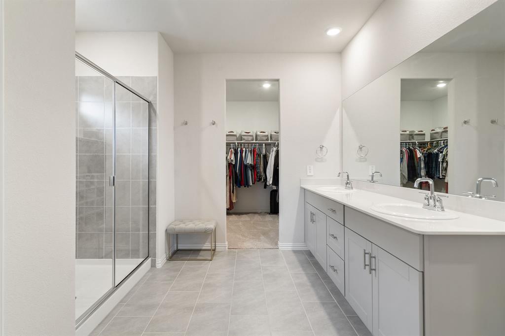 2232 Sun Star Drive Haslet, TX 76052 - Photo 26 of 40 a bathroom with a double vanity sink mirror and shower