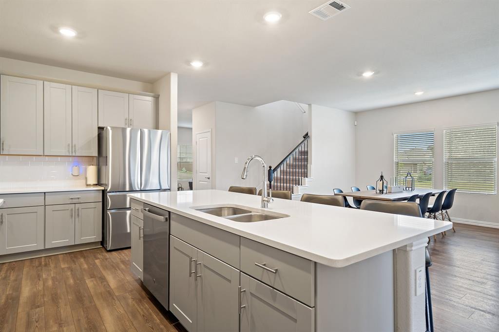 2232 Sun Star Drive Haslet, TX 76052 - Photo 9 of 40 a kitchen that has a sink a stove and chairs