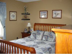 212 Buckboard Road Waynesboro, VA 22980 - Photo 9 of 12 a bedroom with a bed and wall painting