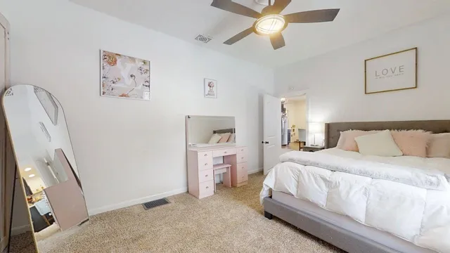 a bedroom with a bed and a mirror