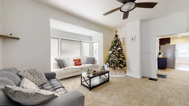 a living room with furniture and a potted plant