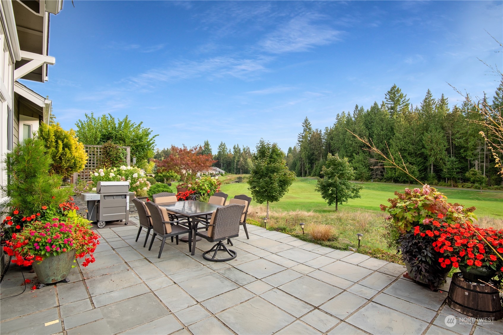 23923 Northeast Adair Road Redmond, WA 98053 - Photo 3 of 38 a view of a table and chairs in back yard of the house