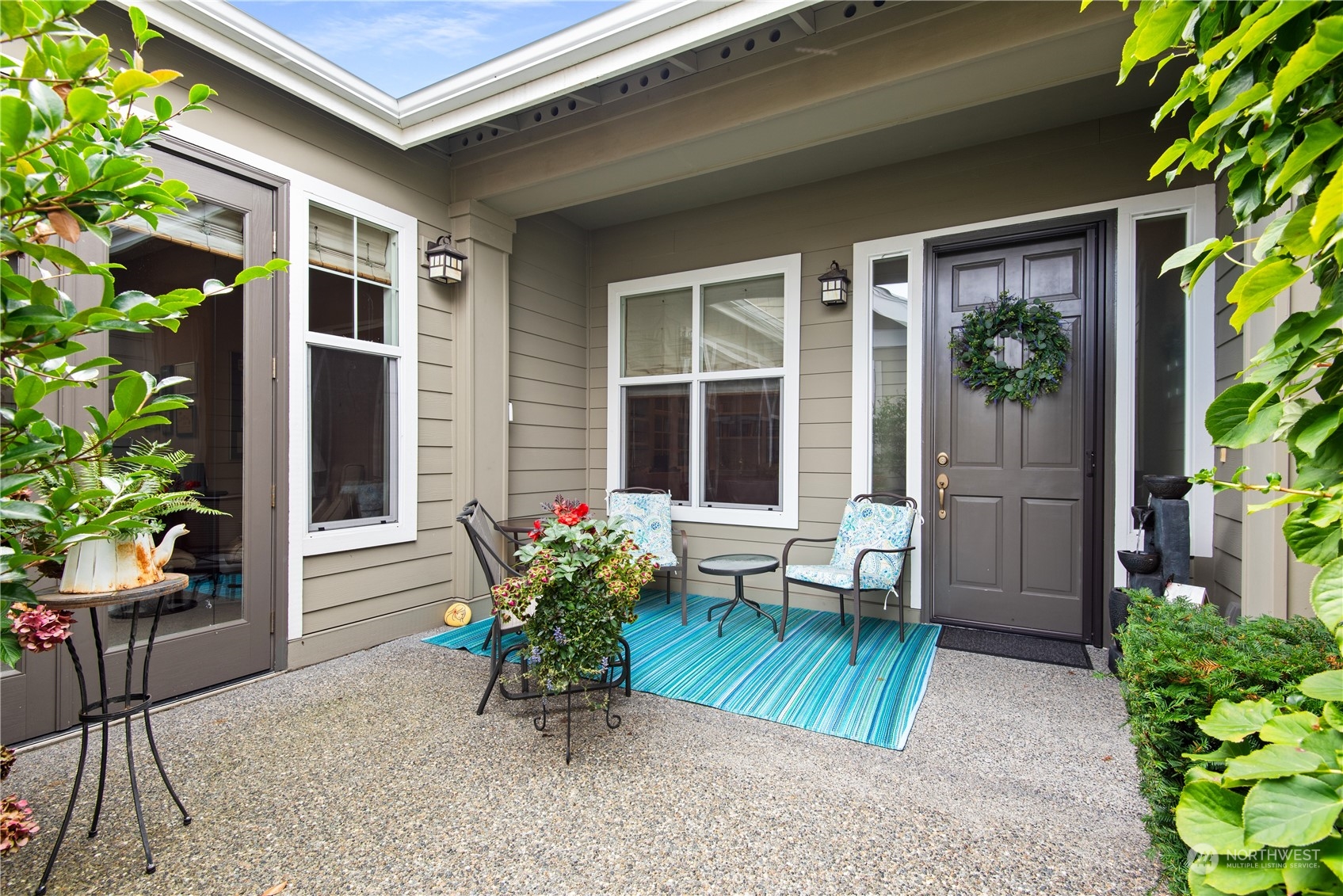 23923 Northeast Adair Road Redmond, WA 98053 - Photo 4 of 38 a view of a house with chairs and table in a patio