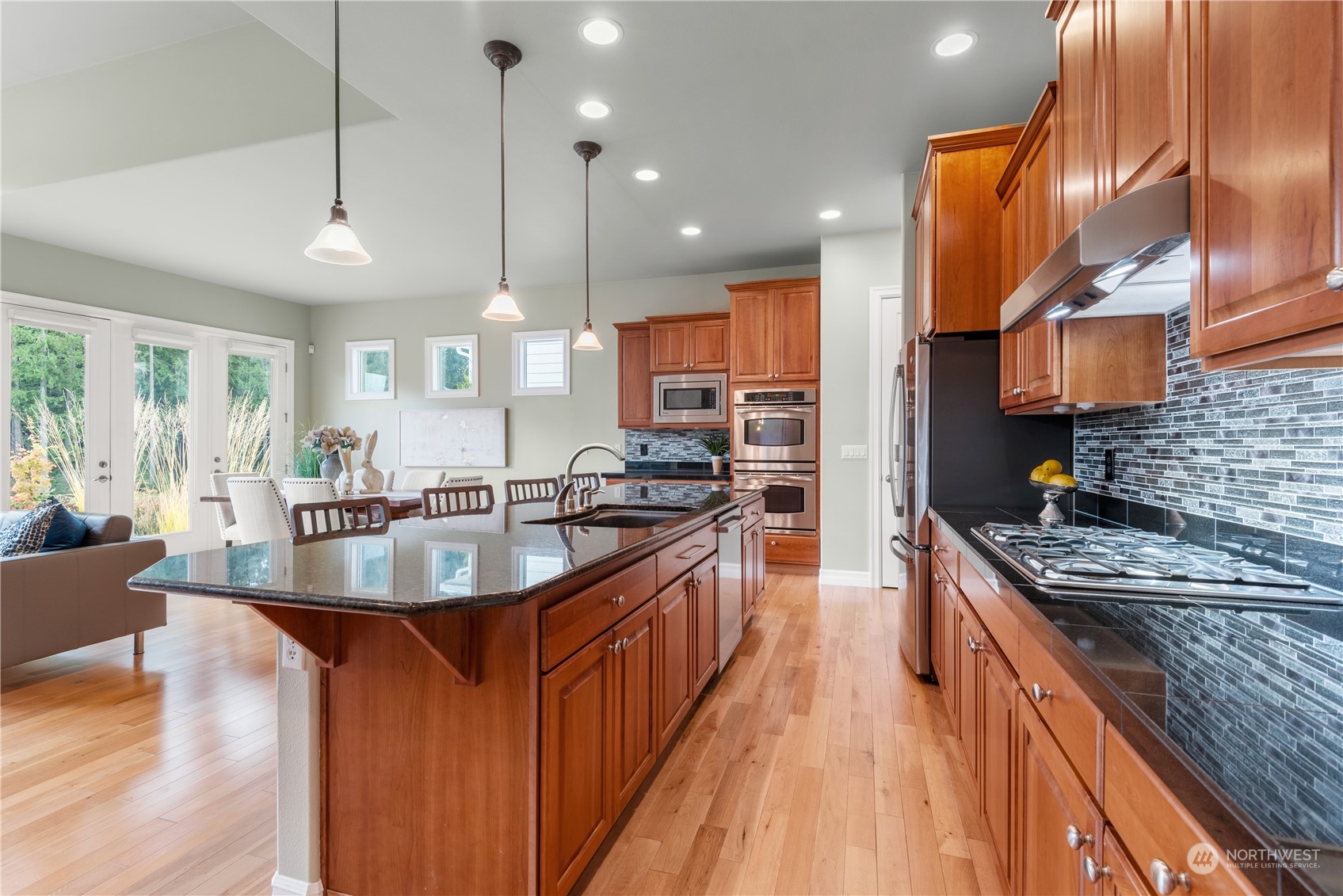 23923 Northeast Adair Road Redmond, WA 98053 - Photo 8 of 38 a large kitchen with stainless steel appliances granite countertop plenty wooden cabinets counter space a sink and a wooden floor
