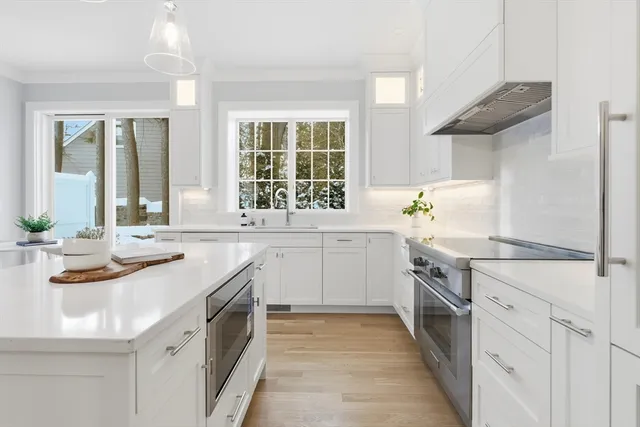 a kitchen with a sink stove and cabinets