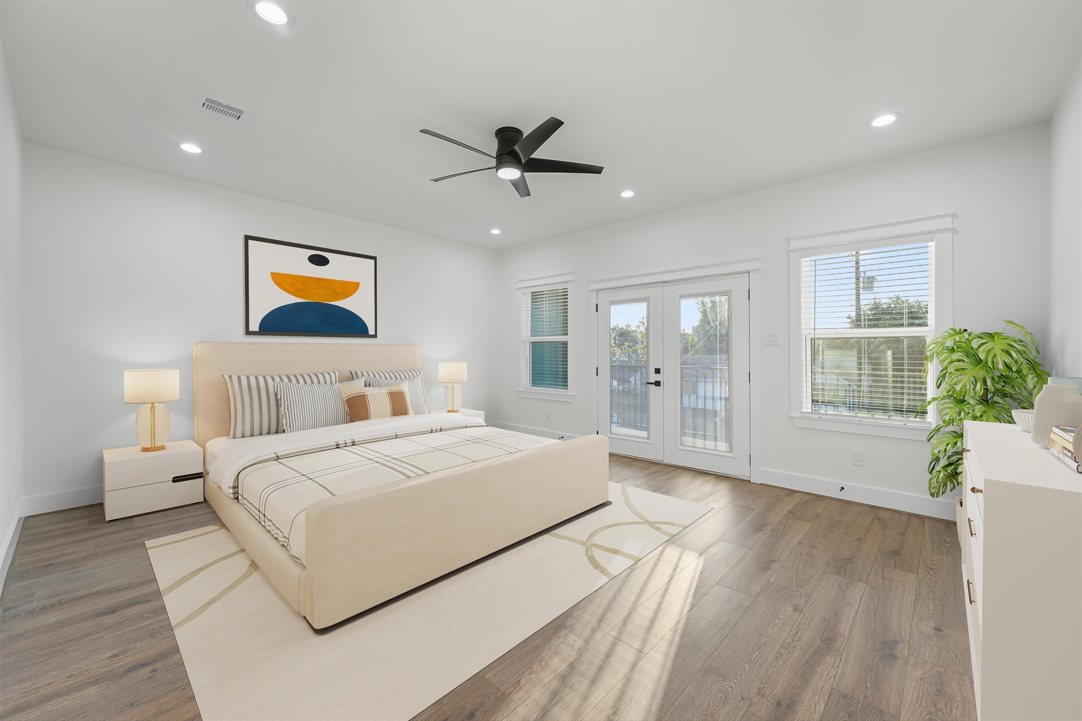 4208 Castor Street, Unit A Houston, TX 77022 - Photo 13 of 23 a bedroom with a large bed and a chandelier